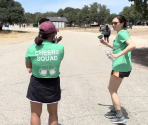 SF Tri Club members wearing "Cheers Squad" t-shirts, standing by and dancing as runners pass by. 