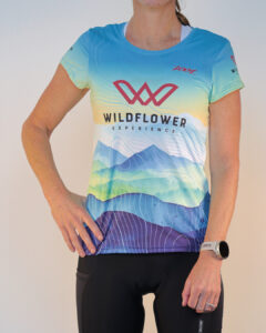 Woman modeling the 2026 Wildflower Experience Training Shirt by Zoot