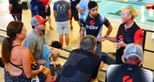 Group of triathletes receiving swim coaching and technique feedback at TriDot Pool School