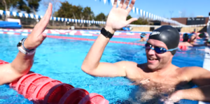 TriDot Pool School swimmers high-fiving during training