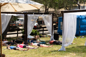 Wildflower yoga attendees laying on their backs.